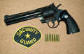 Colt Python .357 6in Replica Revolver, left side with a security guard patch and dummy rounds