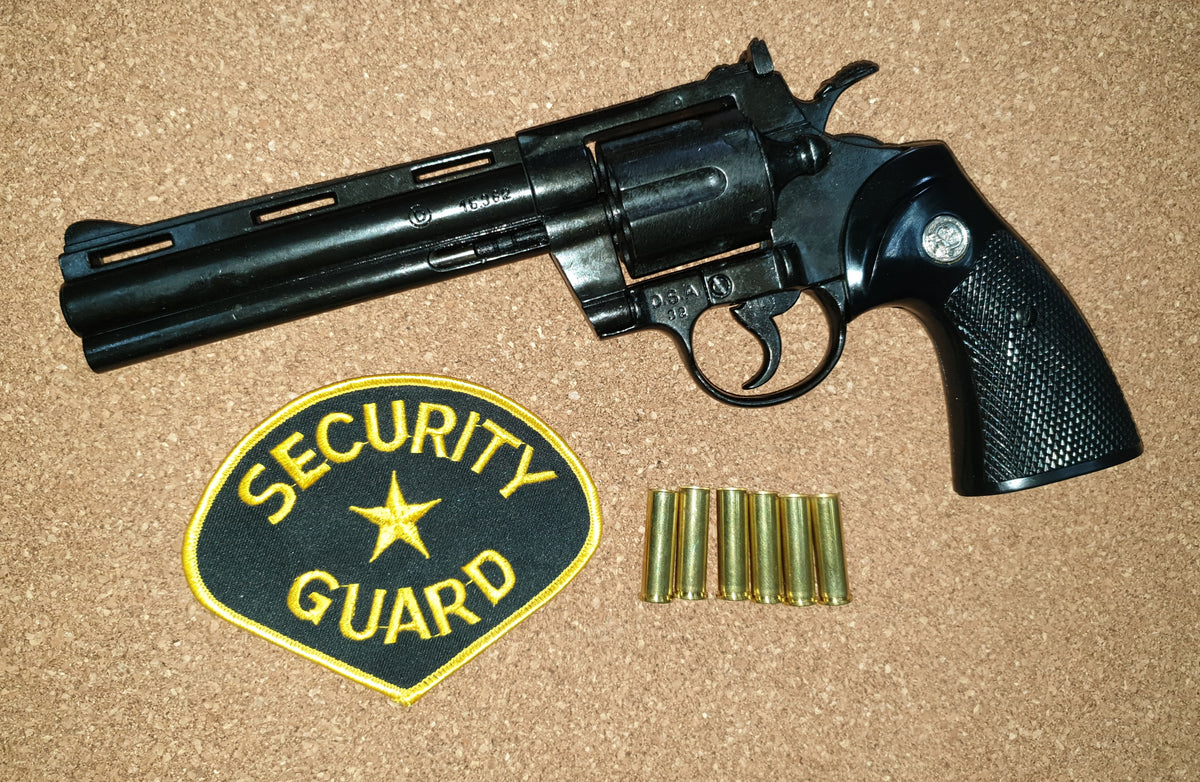 Colt Python .357 6in Replica Revolver, left side with a security guard patch and dummy rounds