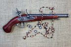 Hadley 1760 Flintlock Pistol Replica, side view with a bead necklace and lead balls