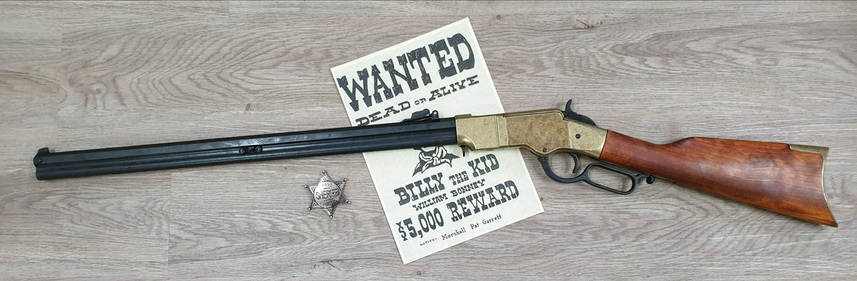 Henry 1860 Lever-Action Rifle Replica, left side, full length with a wanted poster and a badge