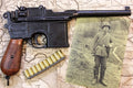 Mauser C96 'Broomhandle' Replica Pistol (Wooden Grips), side view on an old map, with a stripper clip of dummy rounds and a period photograph