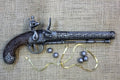 Liège Flintlock Pistol Replica, Late 18th Century, side view with lead balls and a brass ribbon
