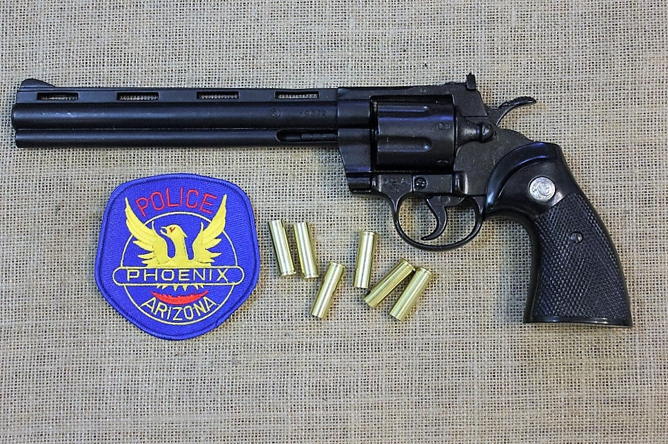 Colt Python .357 8in Replica Revolver, left side with a police patch and dummy rounds