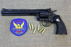 Colt Python .357 8in Replica Revolver, left side with a police patch and dummy rounds