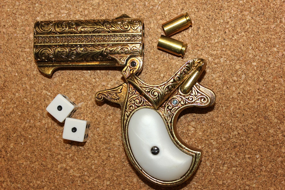 Double-Barrel Derringer 1866 Replica Pistol (Engraved Brass), barrels tipped open, with dice