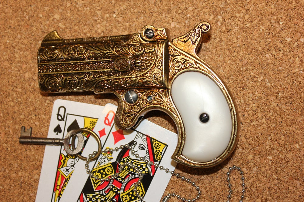 Double-Barrel Derringer 1866 Replica Pistol (Engraved Brass), left side with playing cards