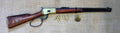 Winchester 1892 Large-Loop Carbine Replica, right side, full length with dummy rounds and a badge