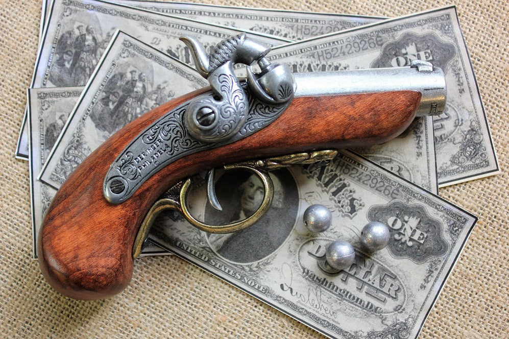 Baby Philadelphia Deringer Replica Pistol, USA 1850, side view with old banknotes and lead balls